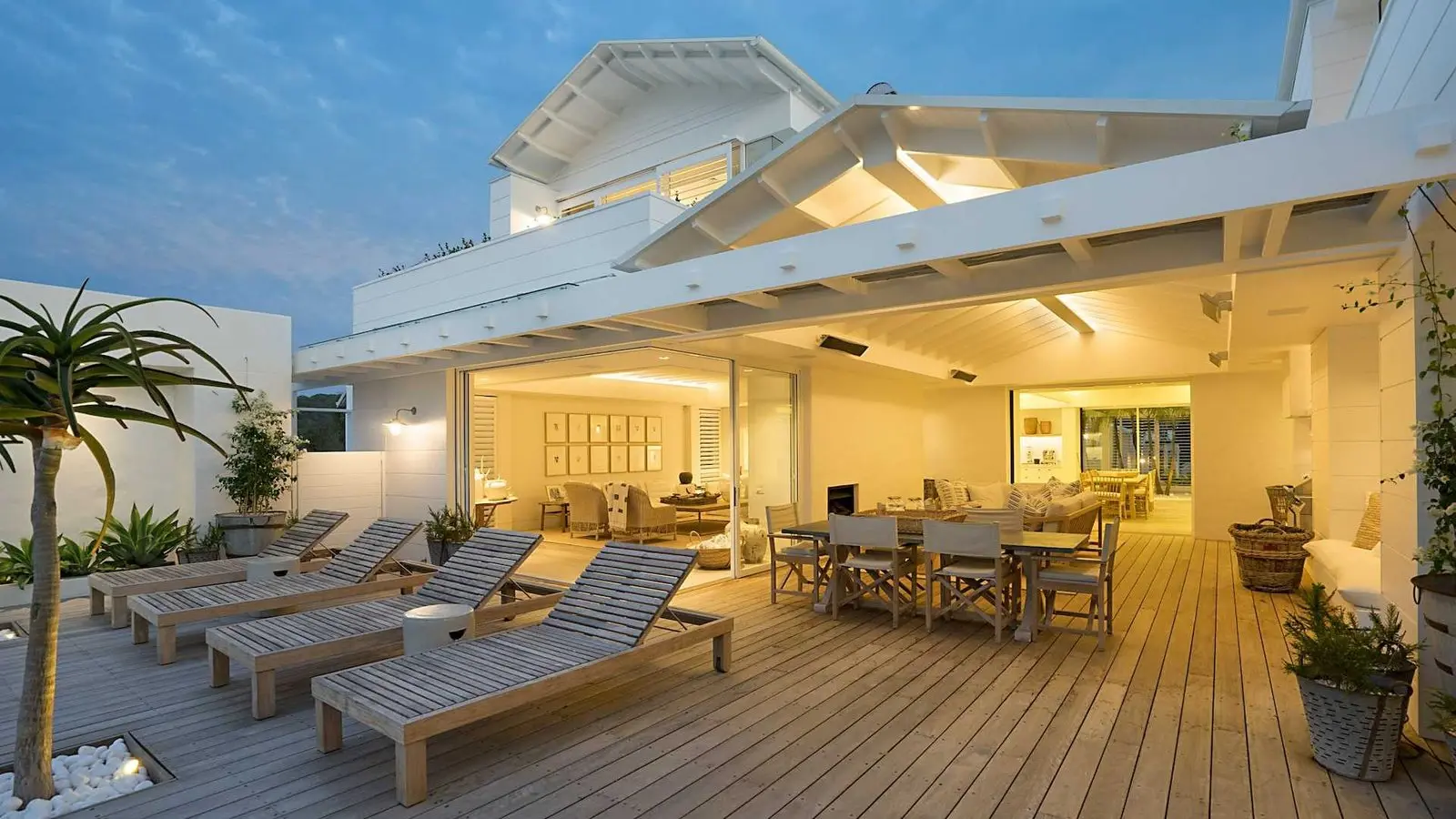 Terrasse en bois éclairée avec bains de soleil
